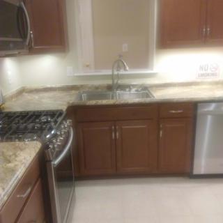 Modern kitchen with wooden cabinets and built-in appliances.