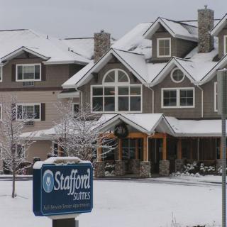 Snow-covered residential building with a visible sign during winter.