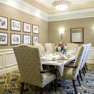 An elegant dining room with a formal table setting and classic decor.