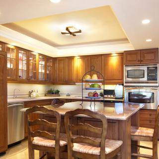 Elegant kitchen with wooden cabinets and a central island.