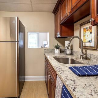 A modern kitchen with stainless steel appliances and granite countertops.