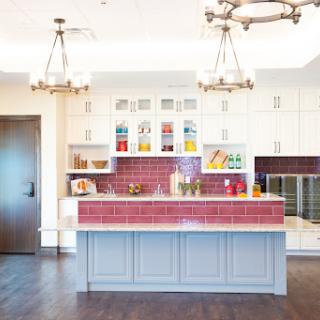 A bright and modern kitchen featuring colorful accents and stylish lighting.