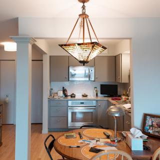 An inviting kitchen and dining area featuring modern appliances and elegant lighting.