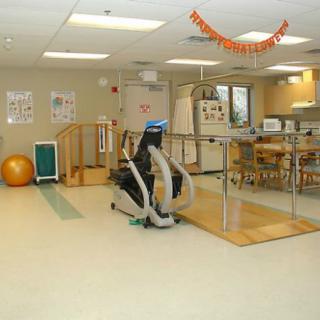 A rehabilitation center featuring various exercise equipment and therapy tools.