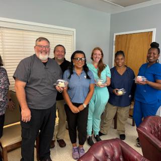 A cheerful gathering of team members celebrating a special occasion.