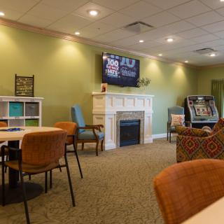 A cozy living room with a fireplace, television, and seating area.