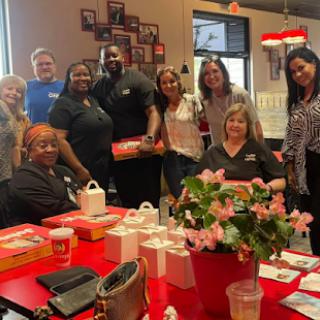 A joyful team gathering filled with smiles and delicious food!