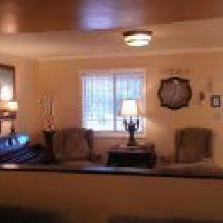Cozy living room with seating arrangement and soft lighting.