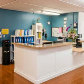 A well-organized reception area with a desk and various office supplies.
