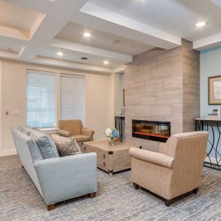 A modern living room with a contemporary fireplace and comfortable seating.