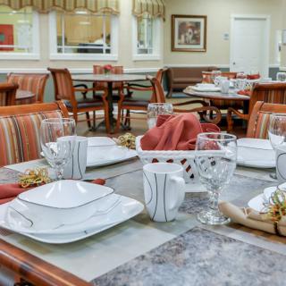 A well-set dining table in a cozy restaurant or dining area.