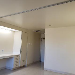 A minimalist interior view of an empty room featuring plain walls and a simple design.