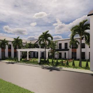 A modern building with palm trees and a cloudy sky.