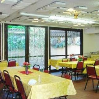 An interior view of a banquet hall with tables and chairs set up for an event.