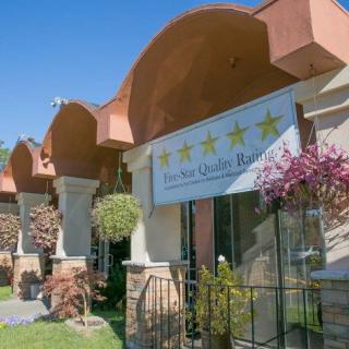 The exterior of a hotel with an elegant architectural design and well-maintained landscaping.