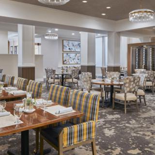 A modern and elegant dining area in a restaurant, featuring neatly arranged tables and stylish chairs.