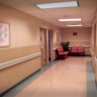 A quiet hospital hallway with seating area.