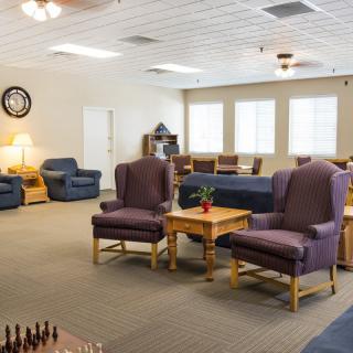 A cozy living room with comfortable seating and ambient lighting.