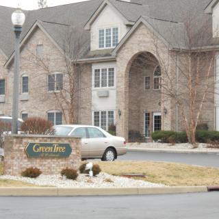 A residential apartment complex with a parked car in front.