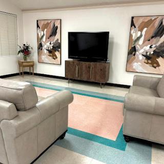 A cozy living room featuring contemporary furniture and artistic wall decor.