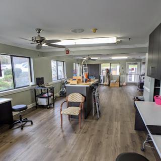 A spacious and well-lit office interior featuring various workstations and furniture.