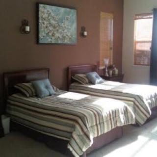 A cozy bedroom with twin beds and modern decor.