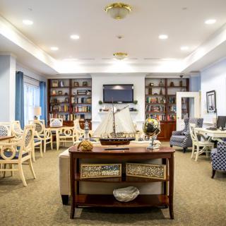 A cozy living room with bookshelves and comfortable seating.