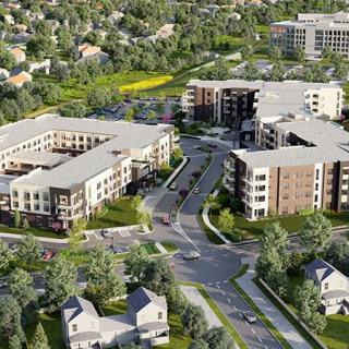Aerial view of a modern residential complex with surrounding greenery.