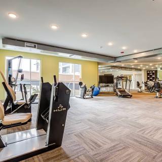 A modern gym with various exercise equipment, including treadmills and fitness machines.