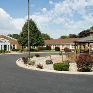 A serene residential community featuring landscaped gardens and a gazebo.