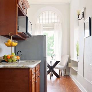 A bright kitchen and dining area with wooden cabinets and a modern design.
