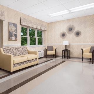 A well-lit waiting room with comfortable seating and decorative artwork.