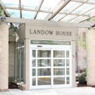 Entrance to Landow House with glass doors and a canopy.