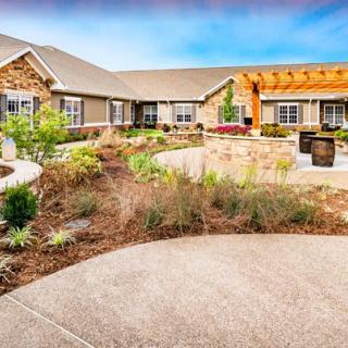 A well-maintained courtyard with lush greenery and modern architecture.