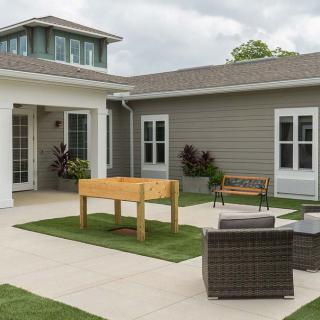 A modern courtyard with outdoor furniture and a landscaped design.