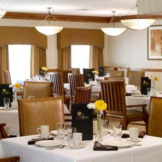 A well-appointed restaurant dining room with neatly arranged tables and chairs, creating an elegant and formal atmosphere.