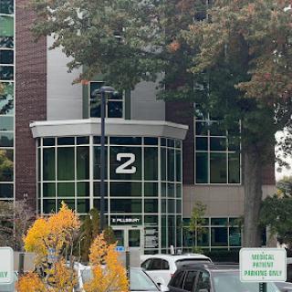 The entrance of a modern office building featuring the number '2' prominently displayed.