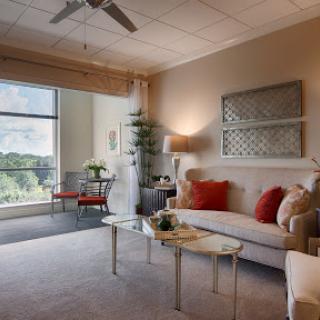 A beautifully designed living room featuring modern decor and a bright window view.