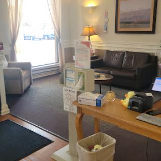 A cozy waiting area featuring comfortable seating and ample natural light.