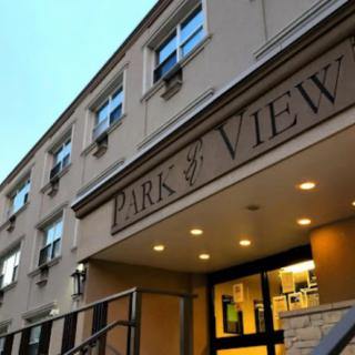 The entrance of Park View apartments in the evening light.