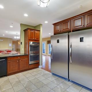 A modern kitchen with stainless steel appliances and wooden cabinets.