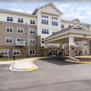 A multi-story residential building with an entrance canopy.
