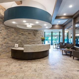 A modern reception area with stylish stone walls and contemporary furniture.