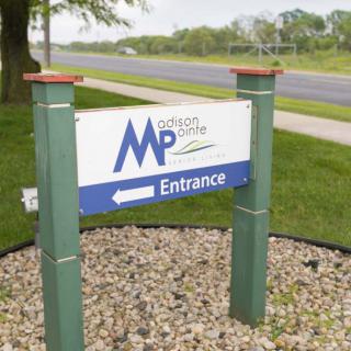 Outdoor entrance sign for 'MP Midwest Perlite' by a roadside.