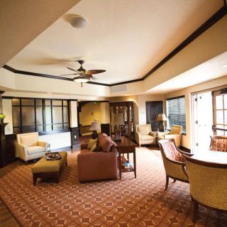A spacious and elegantly decorated living room with comfortable seating and warm lighting.