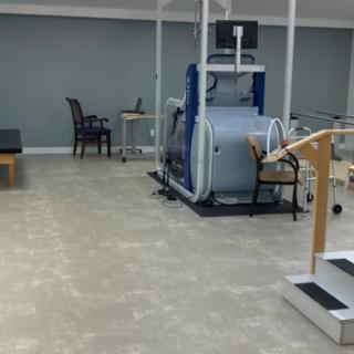A rehabilitation clinic with exercise equipment and therapy tools.