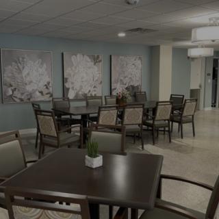 A spacious dining area with neatly arranged tables and chairs, adorned with floral artwork on the walls.