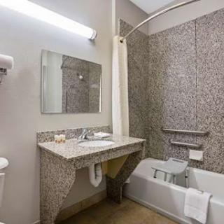 A modern bathroom featuring a shower, sink, and bathtub.