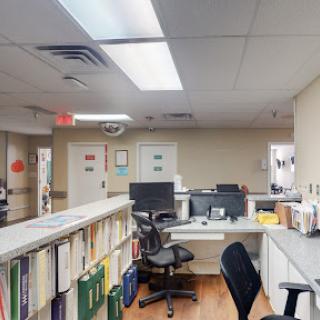 A view of a medical office workspace with computers and organized documents.