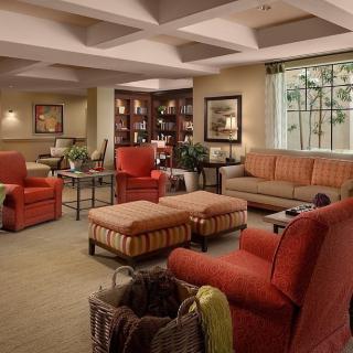 A cozy and modern living room with comfortable seating and warm lighting.